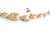 Detalle de broche de collar hecha de varias elipses en oro amarillo texturizado, en el broche un halo de diamantes Nanis Colección Dancing in the rain
